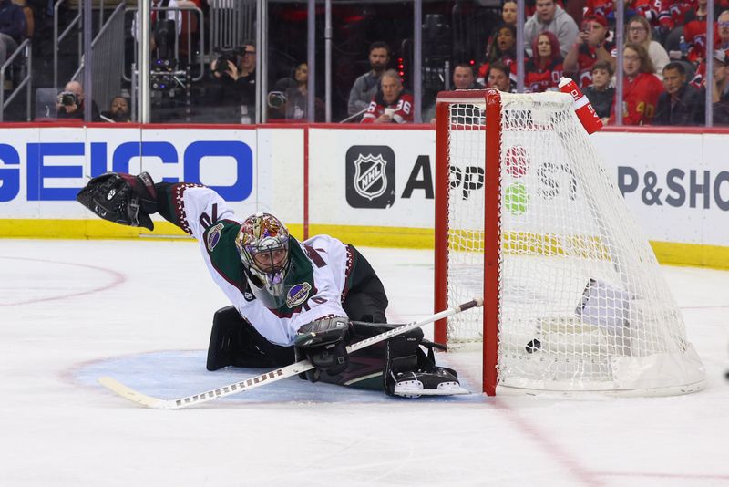 Oct 13, 2023; Newark, New Jersey, USA; Arizona Coyotes goaltender Karel Vejmelka (70) fails to make a save during the second period against New Jersey Devils at Prudential Center. Mandatory Credit: Ed Mulholland-USA TODAY Sports