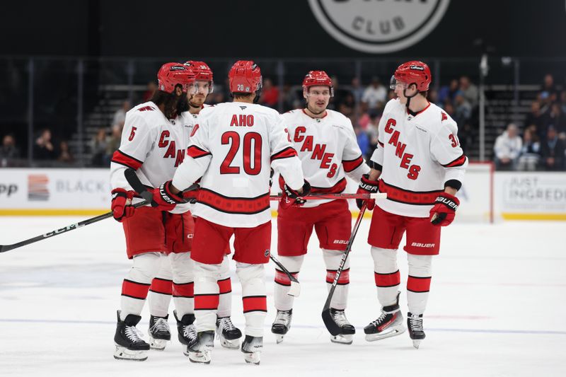 Nov 13, 2024; Salt Lake City, Utah, USA; The Carolina Hurricanes huddle during the first period against the Utah Hockey Club at Delta Center. Mandatory Credit: Rob Gray-Imagn Images