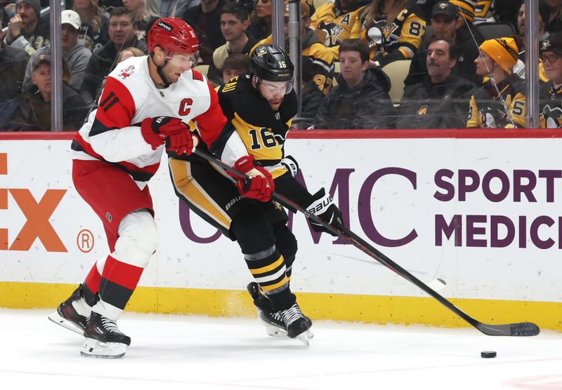 Dec 30, 2025; Pittsburgh, Pennsylvania, USA; Carolina Hurricanes center Jordan Staal (11) and Pittsburgh Penguins right wing Justin Brazeau (16) chase a loose puck during the first period at PPG Paints Arena. Mandatory Credit: Charles LeClaire-Imagn Images