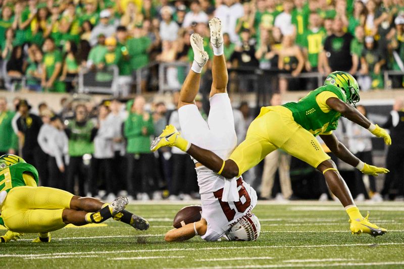 Oct 1, 2022; Eugene, Oregon, USA; Stanford Cardinal wide receiver Brycen Tremayne (81) is upended during the first half by Oregon Ducks defensive back Bryan Addison (13) at Autzen Stadium. Mandatory Credit: Troy Wayrynen-USA TODAY Sports