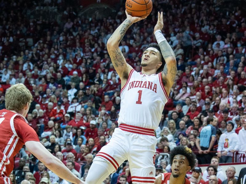 Jan 14, 2023; Bloomington, Indiana, USA; Indiana Hoosiers guard Jalen Hood-Schifino (1) shoots the ball while Wisconsin Badgers forward Steven Crowl (22) defends in the first half at Simon Skjodt Assembly Hall. Mandatory Credit: Trevor Ruszkowski-USA TODAY Sports