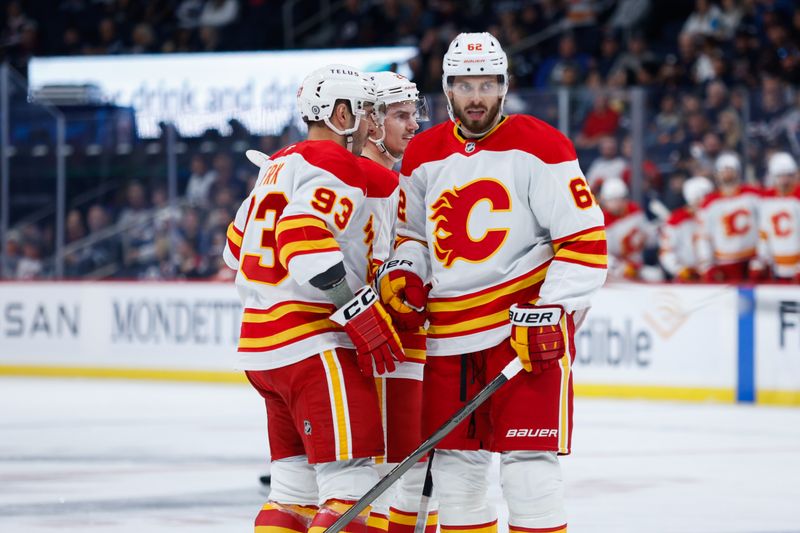 Oct 2, 2024; Winnipeg, Manitoba, CAN;  Calgary Flames forward Martin Frk (93) is congratulated by Calgary Flames defenseman Daniil Miromanov (62) on his goal against the Winnipeg Jets during the first period at Canada Life Centre. Mandatory Credit: Terrence Lee-Imagn Images