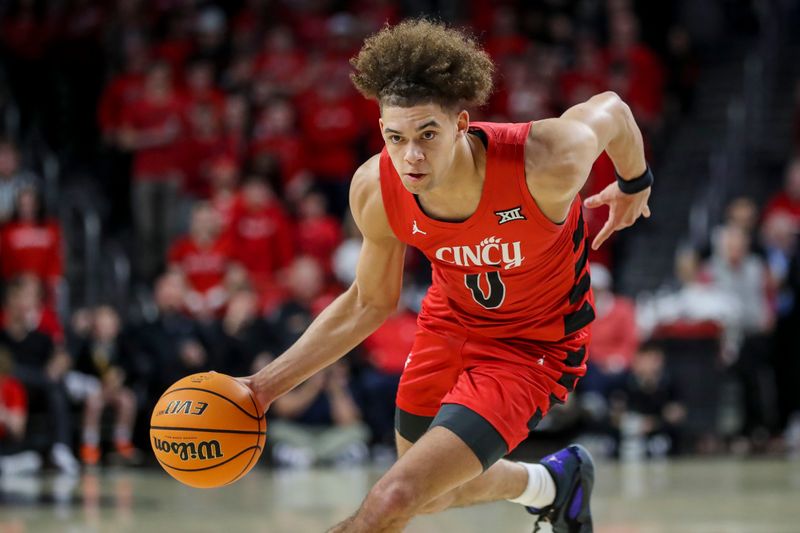 Mar 9, 2024; Cincinnati, Ohio, USA; Cincinnati Bearcats guard Dan Skillings Jr. (0) dribbles against the West Virginia Mountaineers in the first half at Fifth Third Arena. Mandatory Credit: Katie Stratman-USA TODAY Sports