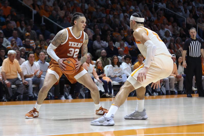 Jan 28, 2023; Knoxville, Tennessee, USA; Texas Longhorns forward Christian Bishop (32) looks to move the ball against Tennessee Volunteers forward Olivier Nkamhoua (13) during the second half at Thompson-Boling Arena. Mandatory Credit: Randy Sartin-USA TODAY Sports