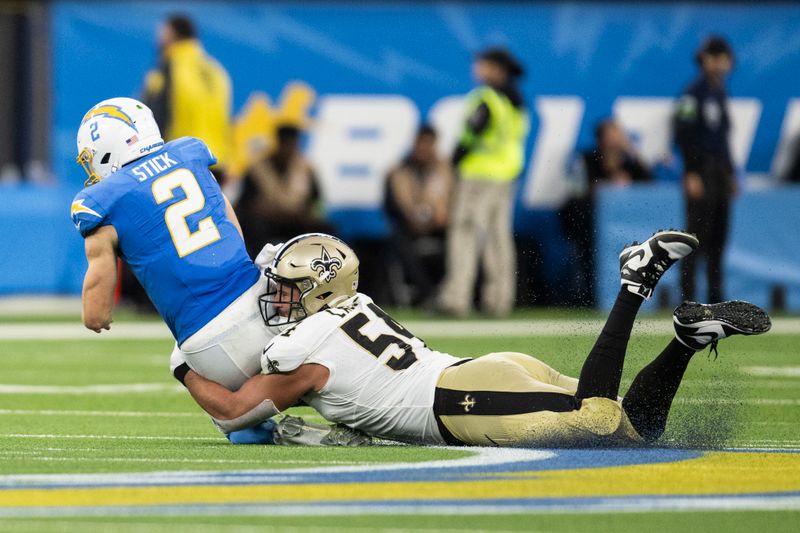 New Orleans Saints defensive end Niko Lalos (54) tackles Los Angeles Chargers quarterback Easton Stick (2) during an NFL preseason football game, Sunday, Aug. 20, 2023, in Inglewood, Calif. (AP Photo/Kyusung Gong)