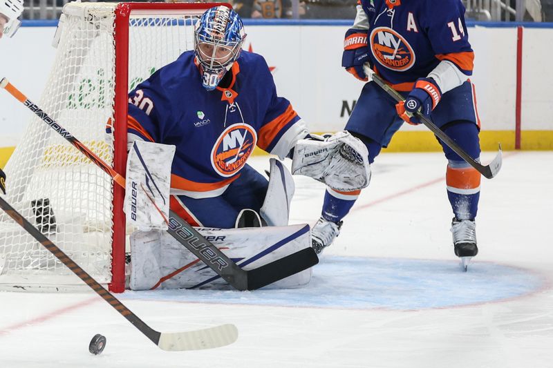 Nov 26, 2025; Elmont, New York, USA; New York Islanders goaltender Ilya Sorokin (30) defends the net against a shot on goal attempt in the first period against the Boston Bruins at UBS Arena. Mandatory Credit: Wendell Cruz-Imagn Images