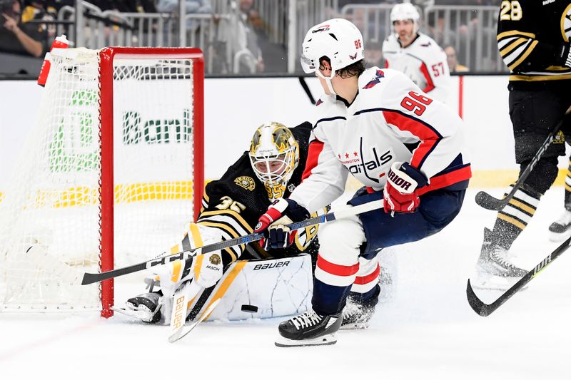 Oct 3, 2023; Boston, Massachusetts, USA;  Boston Bruins goaltender Linus Ullmark (35) blocks a shot against Washington Capitals right wing Nicolas Aube-Kubel (96) during the second period at TD Garden. Mandatory Credit: Bob DeChiara-USA TODAY Sports