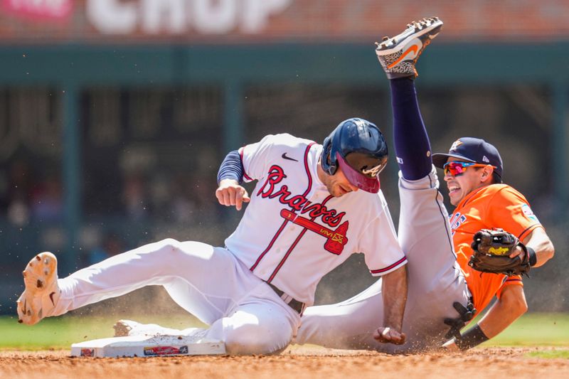 Apr 23, 2023; Cumberland, Georgia, USA; Atlanta Braves first baseman Matt Olson (28) takes out Houston Astros second baseman Mauricio Dubon (14) causing an error on a throw during the sixth inning at Truist Park. Mandatory Credit: Dale Zanine-USA TODAY Sports