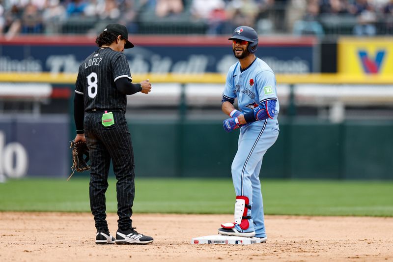 May 27, 2024; Chicago, Illinois, USA; Toronto Blue Jays third baseman Isiah Kiner-Falefa (7) smiles after hitting a double against the Chicago White Sox during the fourth inning at Guaranteed Rate Field. Mandatory Credit: Kamil Krzaczynski-USA TODAY Sports