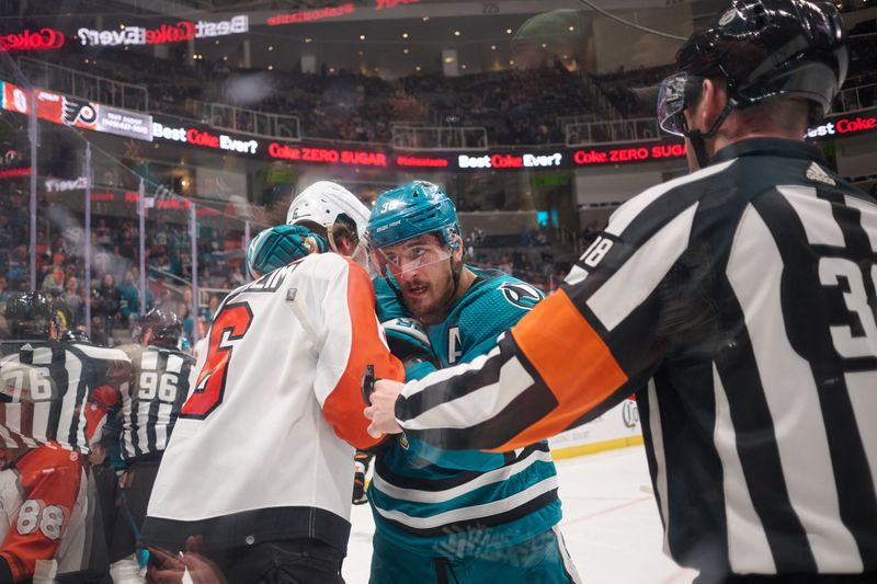 Nov 7, 2023; San Jose, California, USA; San Jose Sharks defenseman Mario Ferraro (38) grabs Philadelphia Flyers defenseman Travis Sanheim (6) in the corner and referee Peter MacDougall (38) watches the play during the first period at SAP Center at San Jose. Mandatory Credit: Robert Edwards-USA TODAY Sports