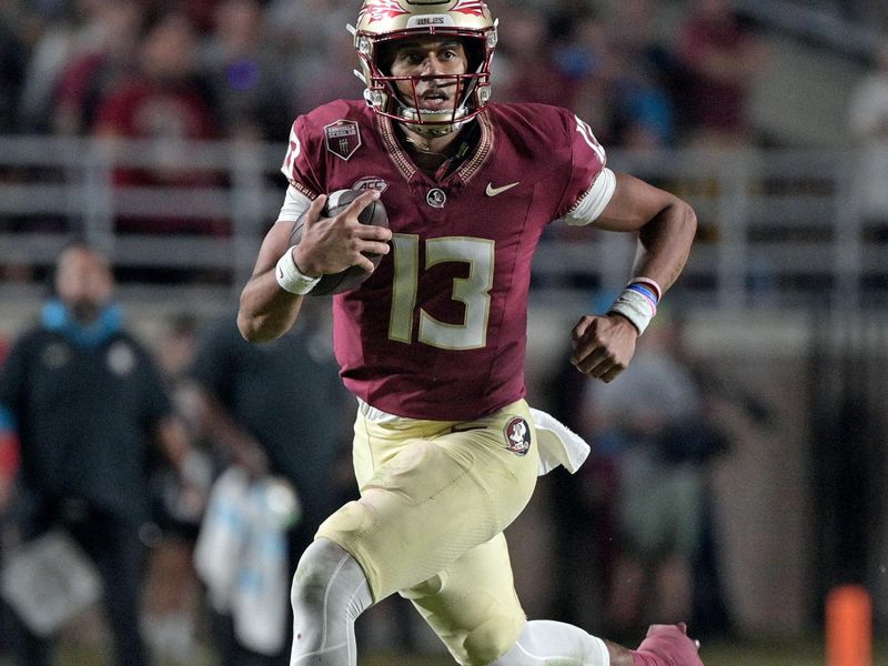 Oct 21, 2023; Tallahassee, Florida, USA; Florida State Seminoles quarterback Jordan Travis (13) runs the ball during the second half against the Duke Blue Devils at Doak S. Campbell Stadium. Mandatory Credit: Melina Myers-USA TODAY Sports