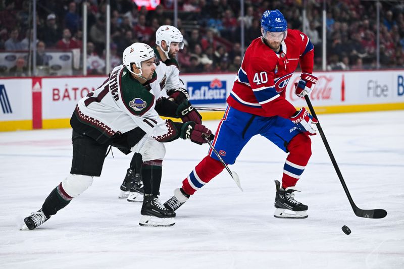 Feb 27, 2024; Montreal, Quebec, CAN; Montreal Canadiens right wing Joel Armia (40) plays the puck against Arizona Coyotes right wing Dylan Guenther (11) during the second period at Bell Centre. Mandatory Credit: David Kirouac-USA TODAY Sports