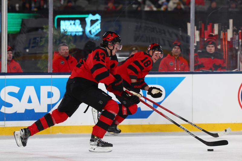 Feb 17, 2024; East Rutherford, New Jersey, USA; New Jersey Devils defenseman Luke Hughes (43) skates with the puck against the Philadelphia Flyers during the first period in a Stadium Series ice hockey game at MetLife Stadium. Mandatory Credit: Ed Mulholland-USA TODAY Sports