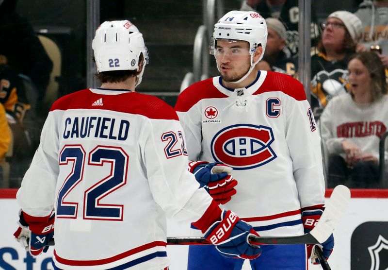 Feb 22, 2024; Pittsburgh, Pennsylvania, USA; Montreal Canadiens center Nick Suzuki (14) talks with Montreal Canadiens right wing Cole Caufield (22) against the Pittsburgh Penguins during the first period at PPG Paints Arena. Mandatory Credit: Charles LeClaire-USA TODAY Sports