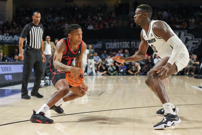 Jan 25, 2023; Orlando, Florida, USA; Houston Cougars guard Marcus Sasser (0) handles the ball in front of UCF Knights forward Lahat Thioune (0) during the second half at Addition Financial Arena. Mandatory Credit: Mike Watters-USA TODAY Sports