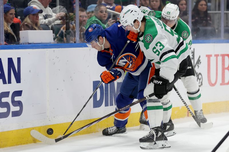 Jan 21, 2024; Elmont, New York, USA; New York Islanders defenseman Noah Dobson (8) fights for the puck against Dallas Stars center Wyatt Johnston (53) and center Roope Hintz (24) during the third period at UBS Arena. Mandatory Credit: Brad Penner-USA TODAY Sports