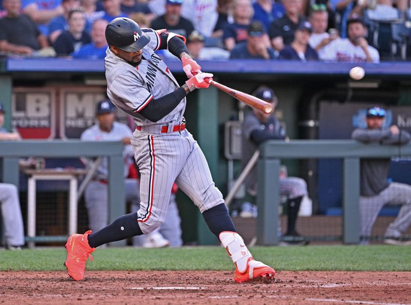 Jul 29, 2023; Kansas City, Missouri, USA;  Minnesota Twins designated hitter Byron Buxton (25) hits a two run double against the Kansas City Royals during the fourth inning at Kauffman Stadium. Mandatory Credit: Peter Aiken-USA TODAY Sports