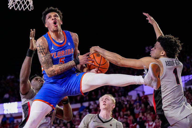 Feb 17, 2024; Athens, Georgia, USA; Florida Gators guard Will Richard (5) is fouled on his way to the basket by Georgia Bulldogs guard Jabri Abdur-Rahim (1) during the second half at Stegeman Coliseum. Mandatory Credit: Dale Zanine-USA TODAY Sports