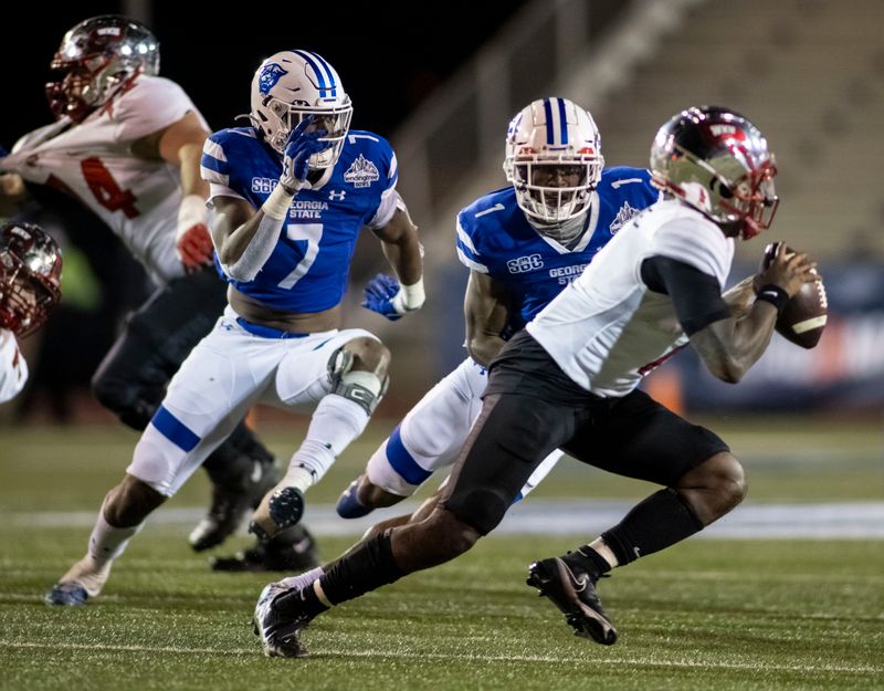 Dec 26, 2020; Mobile, AL, USA; Georgia State Panthers linebacker Jordan Strachan (7) and Georgia State Panthers linebacker Jontrey Hunter (1) pursue Western Kentucky Hilltoppers quarterback Tyrrell Pigrome (1) during the second half at Ladd-Peebles Stadium. Mandatory Credit: Vasha Hunt-USA TODAY Sports