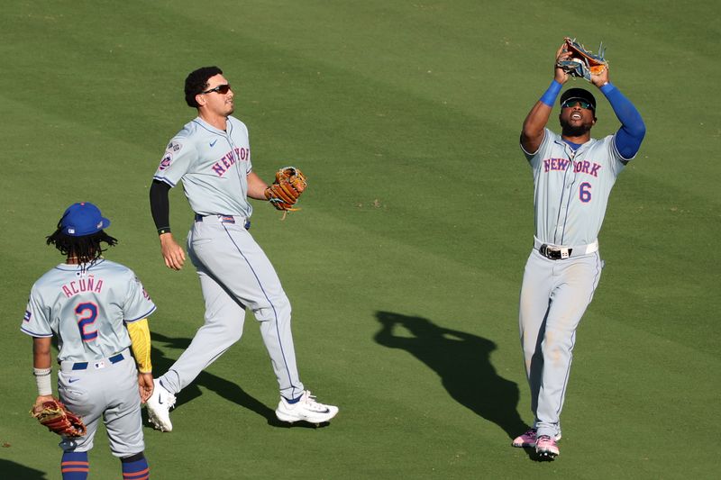 Oct 14, 2024; Los Angeles, California, USA; New York Mets outfielder Starling Marte (6) makes a catch against the Los Angeles Dodgers in the eighth inning during game two of the NLCS for the 2024 MLB Playoffs at Dodger Stadium. Mandatory Credit: Kiyoshi Mio-Imagn Images