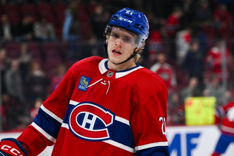 Oct 28, 2023; Montreal, Quebec, CAN; Montreal Canadiens defenseman Kaiden Guhle (21) looks on on his first game back after an injury during warm-up before the game against the Winnipeg Jets at Bell Centre. Mandatory Credit: David Kirouac-USA TODAY Sports