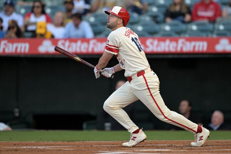 Jun 5, 2024; Anaheim, California, USA;  Los Angeles Angels first baseman Nolan Schanuel (18) hits a lead off solo home run in the first inning against the San Diego Padres at Angel Stadium. Mandatory Credit: Jayne Kamin-Oncea-USA TODAY Sports