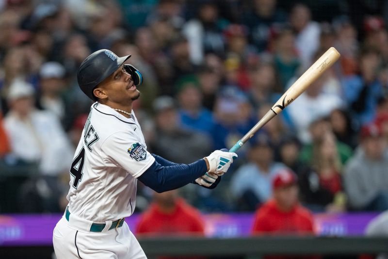 Apr 21, 2023; Seattle, Washington, USA; Seattle Mariners centerfielder Julio Rodriguez (44) hits a single during the third inning against the St. Louis Cardinals at T-Mobile Park. Mandatory Credit: Stephen Brashear-USA TODAY Sports