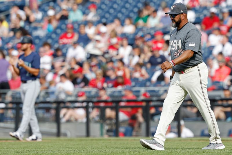 May 25, 2024; Washington, District of Columbia, USA; Washington Nationals manager Dave Martinez (4) walks to the pitcher's mound against the Seattle Mariners during the sixth inning at Nationals Park. Mandatory Credit: Geoff Burke-USA TODAY Sports