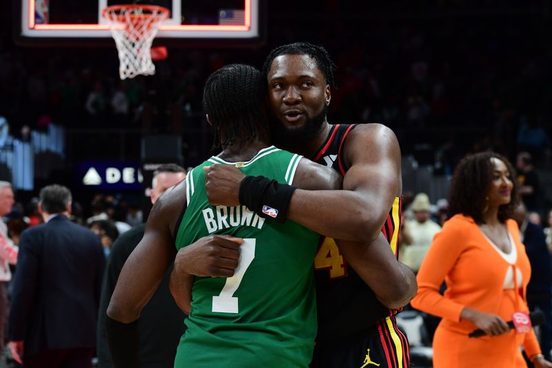 ATLANTA, GA - MARCH 28: Bruno Fernando #24 of the Atlanta Hawks and Jaylen Brown #7 of the Boston Celtics embrace after the game on March 28, 2024 at State Farm Arena in Atlanta, Georgia.  NOTE TO USER: User expressly acknowledges and agrees that, by downloading and/or using this Photograph, user is consenting to the terms and conditions of the Getty Images License Agreement. Mandatory Copyright Notice: Copyright 2024 NBAE (Photo by Scott Cunningham/NBAE via Getty Images)