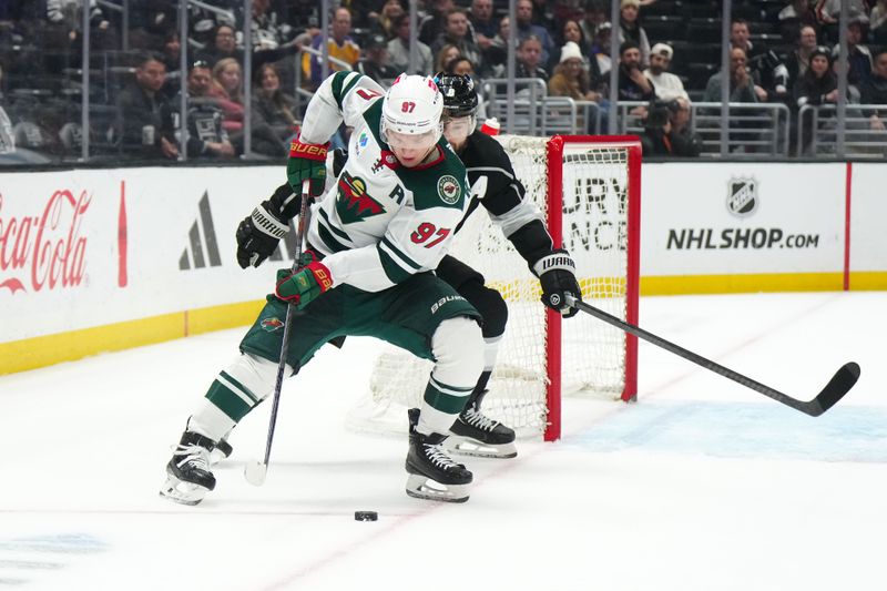 Apr 15, 2024; Los Angeles, California, USA; Minnesota Wild left wing Kirill Kaprizov (97) and LA Kings defenseman Drew Doughty (8) battle for the puck in the third period at Crypto.com Arena. Mandatory Credit: Kirby Lee-USA TODAY Sports