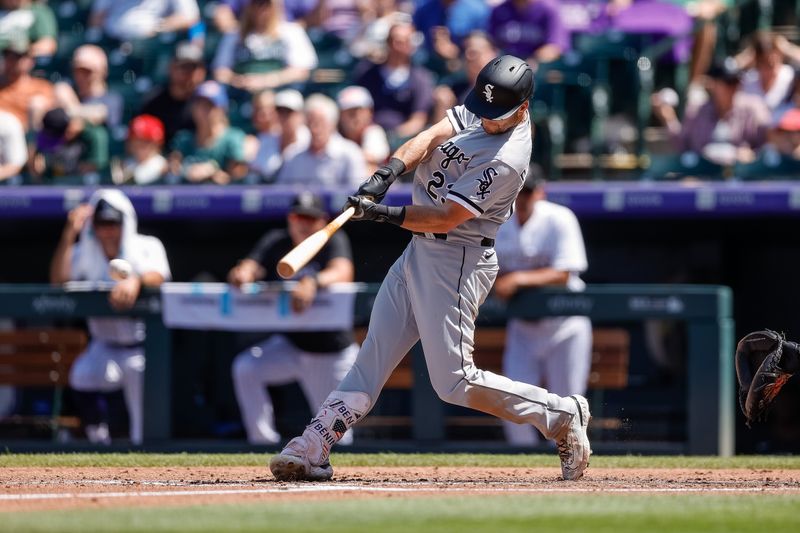 Aug 20, 2023; Denver, Colorado, USA; Chicago White Sox left fielder Andrew Benintendi (23) hits a single in the third inning against the Colorado Rockies at Coors Field. Mandatory Credit: Isaiah J. Downing-USA TODAY Sports