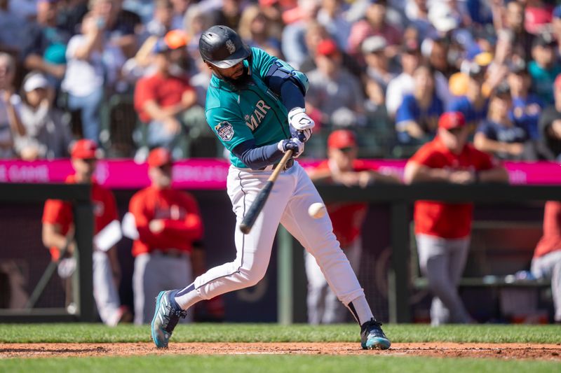 Sep 13, 2023; Seattle, Washington, USA; Seattle Mariners right fielder Teoscar Hernandez (35) hits a RBI-single during the fifth inning against the Los Angeles Angels at T-Mobile Park. Mandatory Credit: Stephen Brashear-USA TODAY Sports