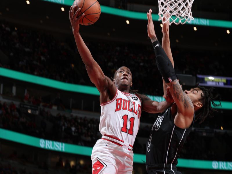 CHICAGO, IL - DECEMBER 2: Ayo Dosunmu #11 of the Chicago Bulls drives to the basket during the game against the Brooklyn Nets on December 2, 2024 at United Center in Chicago, Illinois. NOTE TO USER: User expressly acknowledges and agrees that, by downloading and or using this photograph, User is consenting to the terms and conditions of the Getty Images License Agreement. Mandatory Copyright Notice: Copyright 2024 NBAE (Photo by Jeff Haynes/NBAE via Getty Images)