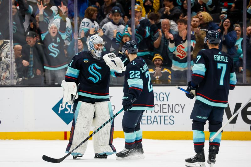 Feb 26, 2024; Seattle, Washington, USA; Seattle Kraken goaltender Philipp Grubauer (31) celebrates with right wing Oliver Bjorkstrand (22) following an overtime shootout victory against the Boston Bruins at Climate Pledge Arena. Mandatory Credit: Joe Nicholson-USA TODAY Sports