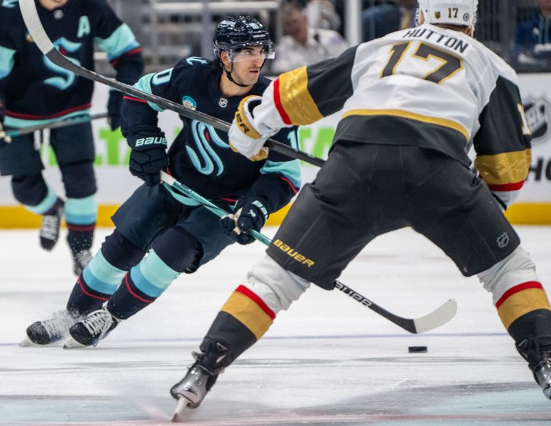 Nov 8, 2024; Seattle, Washington, USA;  Seattle Kraken forward Matty Beniers (10) skates against Vegas Golden Knights defenseman Ben Hutton (17) during the second period at Climate Pledge Arena. Mandatory Credit: Stephen Brashear-Imagn Images