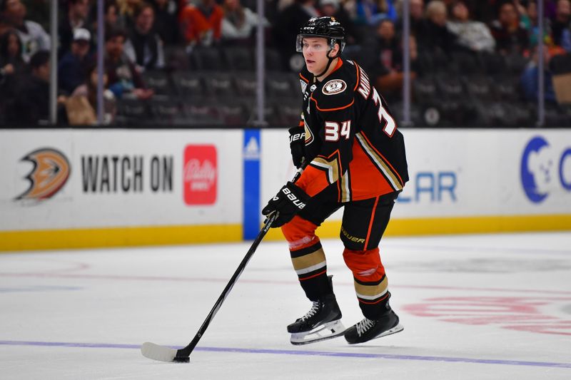 Feb 21, 2024; Anaheim, California, USA; Anaheim Ducks defenseman Pavel Mintyukov (34) controls the puck against the Columbus Blue Jackets during the third period at Honda Center. Mandatory Credit: Gary A. Vasquez-USA TODAY Sports