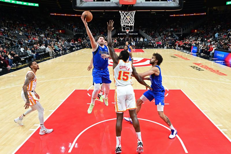 ATLANTA, GA - JANUARY 26: Luka Doncic #77 of the Dallas Mavericks drives to the basket during the game against the Atlanta Hawks on January 26, 2024 at State Farm Arena in Atlanta, Georgia.  NOTE TO USER: User expressly acknowledges and agrees that, by downloading and/or using this Photograph, user is consenting to the terms and conditions of the Getty Images License Agreement. Mandatory Copyright Notice: Copyright 2024 NBAE (Photo by Adam Hagy/NBAE via Getty Images)