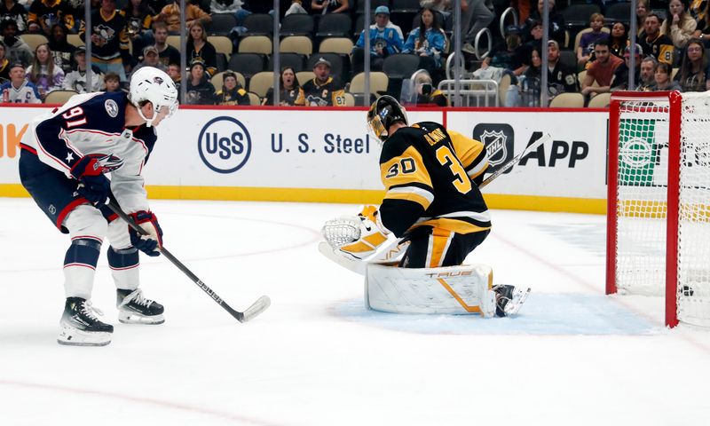 Oct 4, 2024; Pittsburgh, Pennsylvania, USA;  Columbus Blue Jackets center Kent Johnson (91) scores a goal on a breakaway against Pittsburgh Penguins goaltender Joel Blomqvist (30) during the second period at PPG Paints Arena. Mandatory Credit: Charles LeClaire-Imagn Images