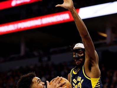 MINNEAPOLIS, MINNESOTA - DECEMBER 16: Karl-Anthony Towns #32 of the Minnesota Timberwolves drives to the basket while Isaiah Jackson #22 of the Indiana Pacers defends in the fourth quarter at Target Center on December 16, 2023 in Minneapolis, Minnesota. The Timberwolves defeated the Pacers 127-109. NOTE TO USER: User expressly acknowledges and agrees that, by downloading and or using this photograph, User is consenting to the terms and conditions of the Getty Images License Agreement. (Photo by David Berding/Getty Images)