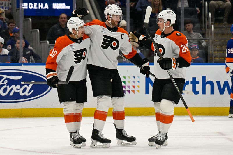 Nov 28, 2025; Elmont, New York, USA; Philadelphia Flyers center Sean Couturier (14) celebrates his goal with Philadelphia Flyers right wing Bobby Brink (10) and Philadelphia Flyers defenseman Nick Seeler (24) against the New York Islanders during the first period at UBS Arena. Mandatory Credit: Dennis Schneidler-Imagn Images
