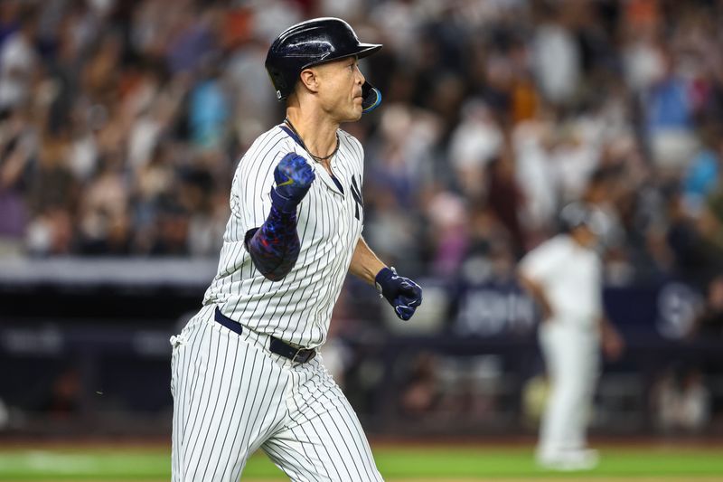 Jun 19, 2024; Bronx, New York, USA;  New York Yankees designated hitter Giancarlo Stanton (27) hits a three-run home run in the seventh inning against the Baltimore Orioles at Yankee Stadium. Mandatory Credit: Wendell Cruz-USA TODAY Sports