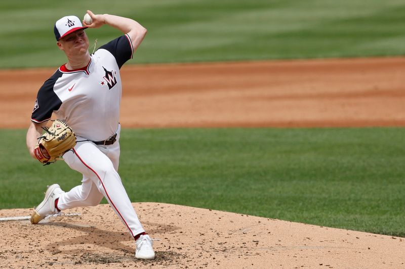 Jun 9, 2024; Washington, District of Columbia, USA; Washington Nationals starting pitcher DJ Herz (74) pitches against the Atlanta Braves during the third inning at Nationals Park. Mandatory Credit: Geoff Burke-USA TODAY Sports