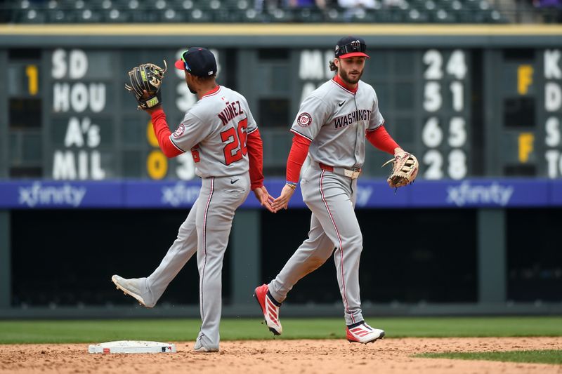 Apr 19, 2025; Denver, Colorado, USA; Washington Nationals outfielder Dylan Crews (3) and shortstop Nasim Nunez (26) celebrate after a win against the Colorado Rockies at Coors Field. Mandatory Credit: Christopher Hanewinckel-Imagn Images