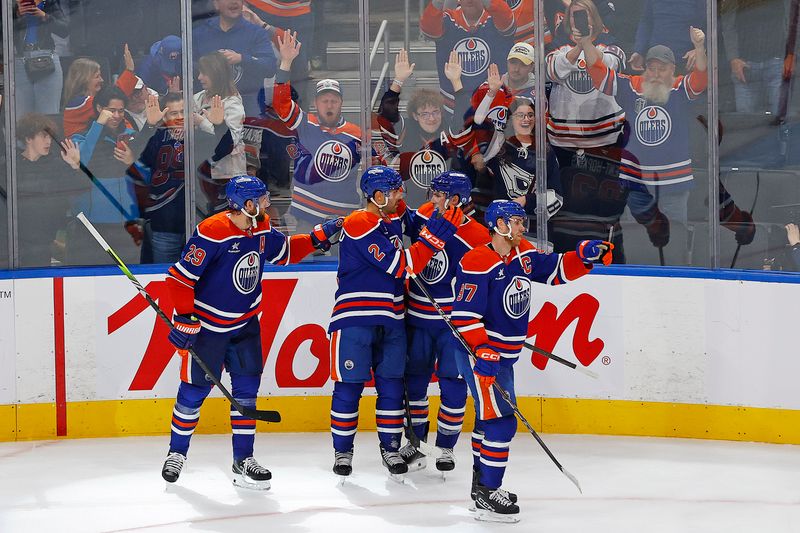 Nov 12, 2024; Edmonton, Alberta, CAN; Edmonton Oilers forward Leon Draisaitl (29) scores the winning goal during overtime against the New York Islanders. The assist by forward Connor McDavid (97) was his 999th point in the NHL at Rogers Place. Mandatory Credit: Perry Nelson-Imagn Images