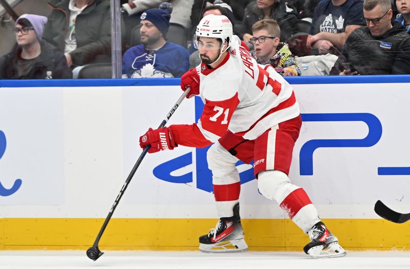 Jan 14, 2024; Toronto, Ontario, CAN;  Detroit Red Wings forward Dylan Larkin (71) shoots the puck against the Toronto Maple Leafs in the third period at Scotiabank Arena. Mandatory Credit: Dan Hamilton-USA TODAY Sports