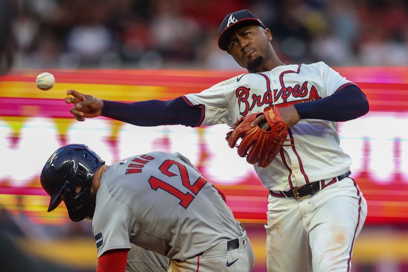 May 8, 2024; Atlanta, Georgia, USA; Atlanta Braves second baseman Ozzie Albies (1) attempts to turn a double play over Boston Red Sox catcher Connor Wong (12) in the third inning at Truist Park. Mandatory Credit: Brett Davis-USA TODAY Sports
