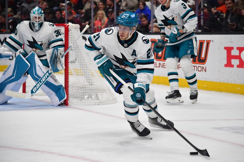 Dec 29, 2025; Anaheim, California, USA; San Jose Sharks center Alexander Wennberg (21) controls the puck against the Anaheim Ducks during the second period at Honda Center. Mandatory Credit: Gary A. Vasquez-Imagn Images