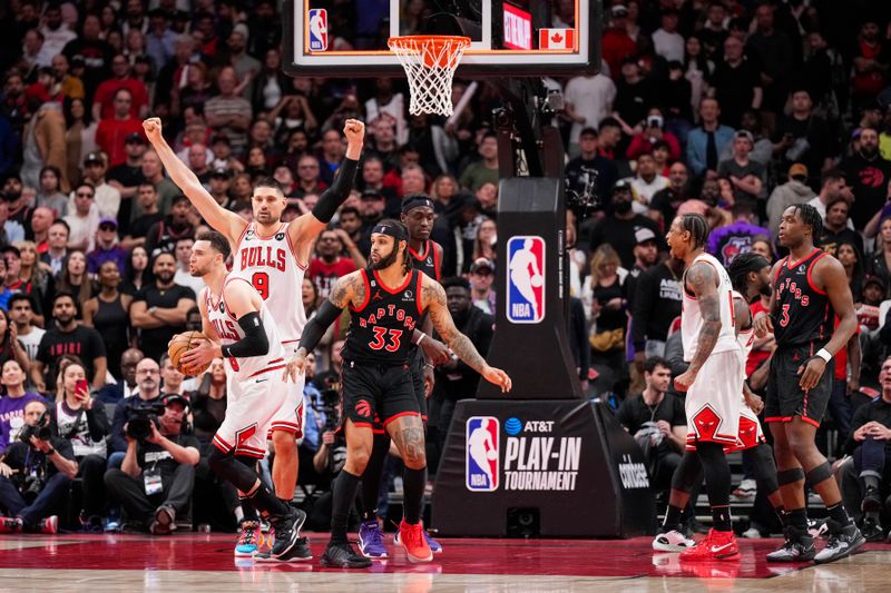 TORONTO, ON - APRIL 12: Zach LaVine #8, Nikola Vucevic #9 and DeMar DeRozan #11 of the Chicago Bulls celebrate after defeating the Toronto Raptors during the 2023 Play-In Tournament at the Scotiabank Arena on April 12, 2023 in Toronto, Ontario, Canada. NOTE TO USER: User expressly acknowledges and agrees that, by downloading and/or using this Photograph, user is consenting to the terms and conditions of the Getty Images License Agreement. (Photo by Andrew Lahodynskyj/Getty Images)