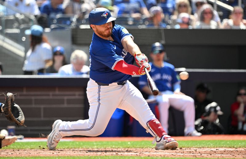 May 19, 2024; Toronto, Ontario, CAN; Toronto Blue Jays catcher Alejandro Kirk (30) hits a two RBI double against the Tampa Bay Rays in the sixth inning at Rogers Centre. Mandatory Credit: Dan Hamilton-USA TODAY Sports