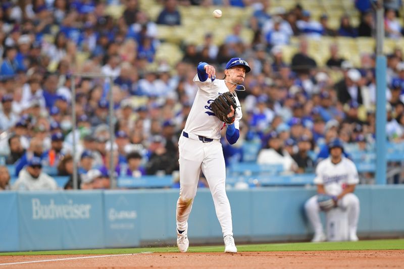 Jun 12, 2024; Los Angeles, California, USA; Los Angeles Dodgers third baseman Cavan Biggio (6) is late on the throw to first against Texas Rangers left fielder Wyatt Langford (36) during the second inning at Dodger Stadium. Mandatory Credit: Gary A. Vasquez-USA TODAY Sports